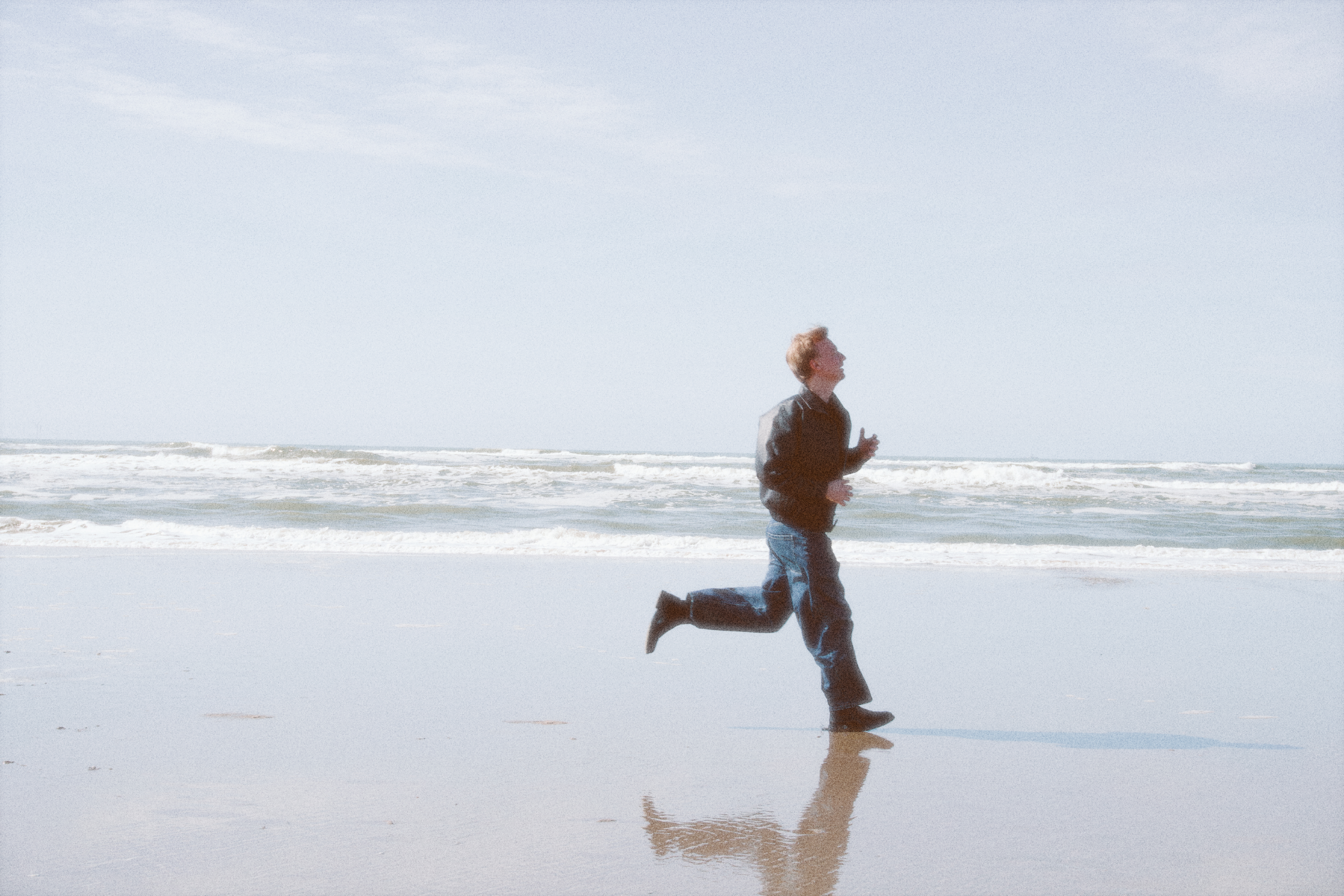 Artist running on the beach